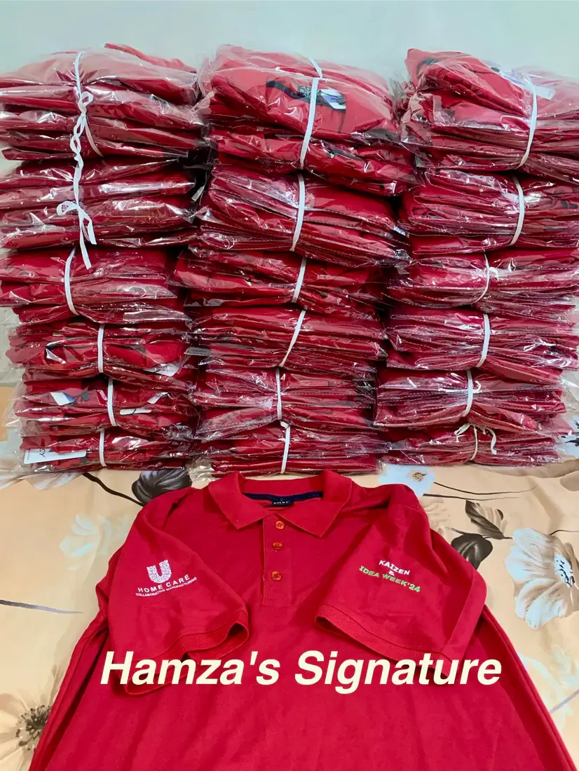 A completed order of embroidered red polo shirts