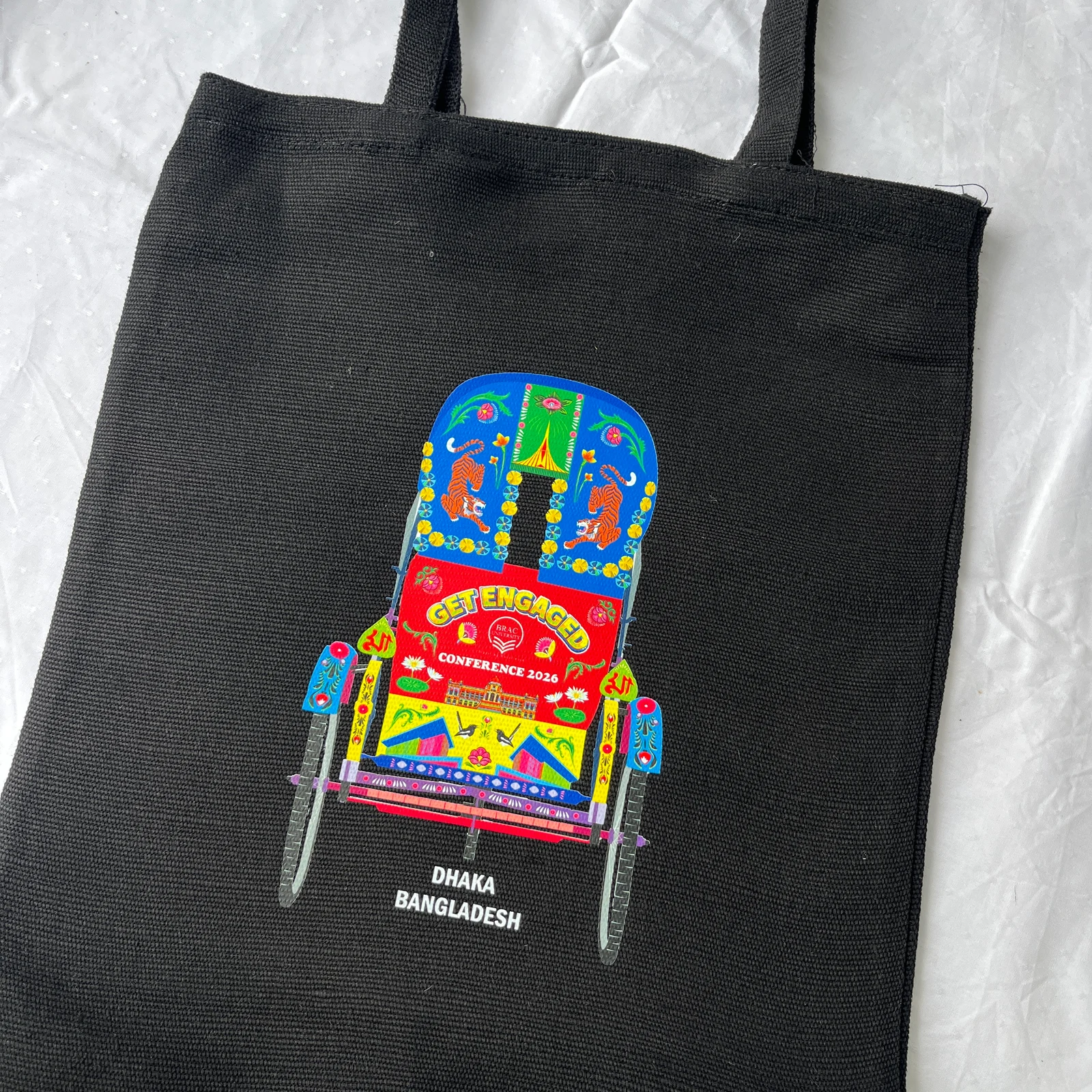 Black tote with colourful rickshaw artwork for Get Engaged Conference 2026