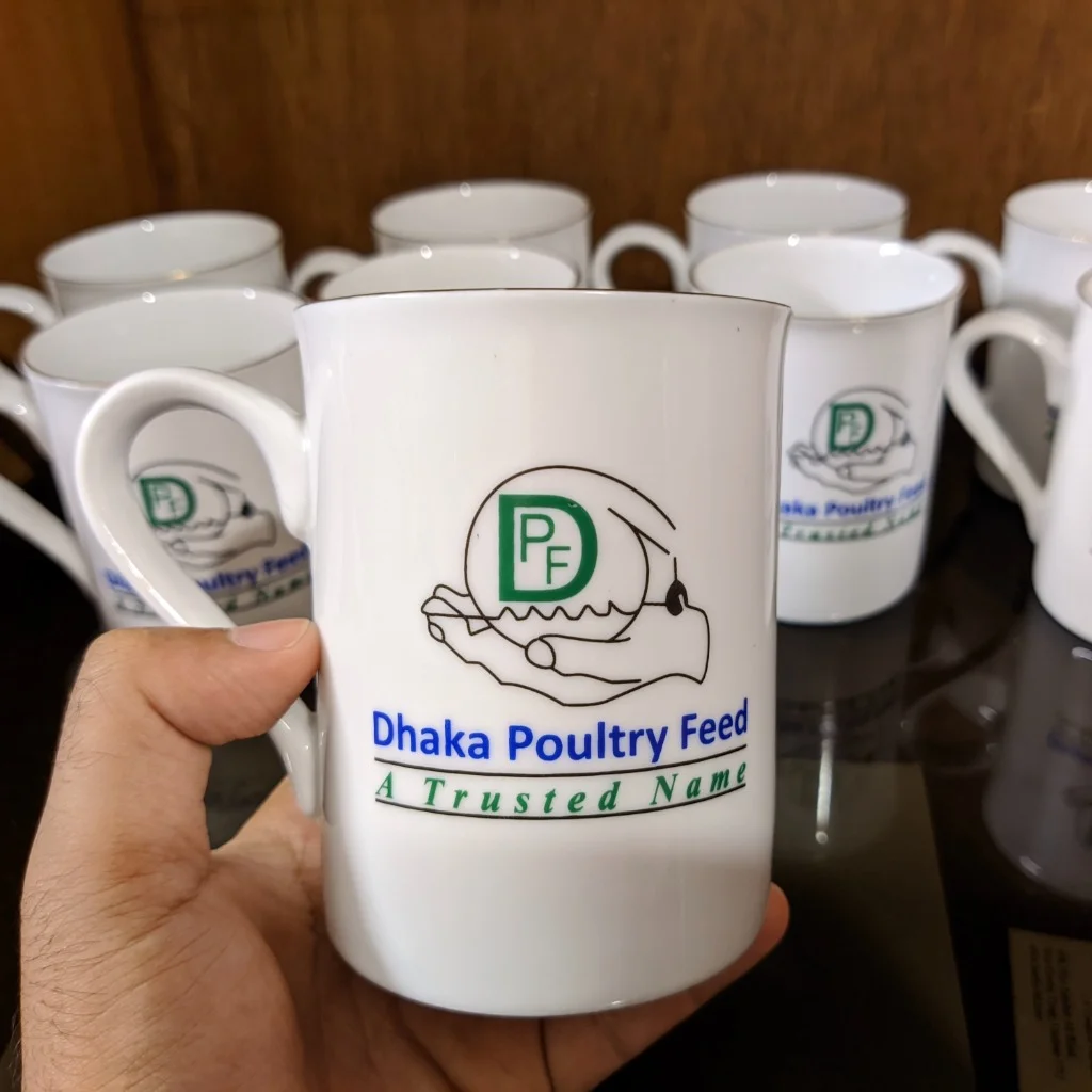Custom printed corporate ceramic mugs with Dhaka Poultry Feed brand logo and platinum rim