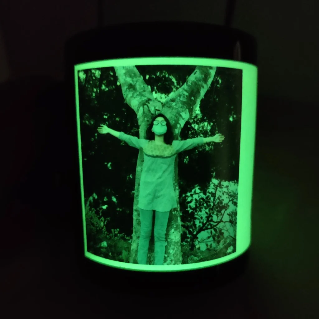 Custom printed glowing ceramic radium mug with portrait photograph in dark environment